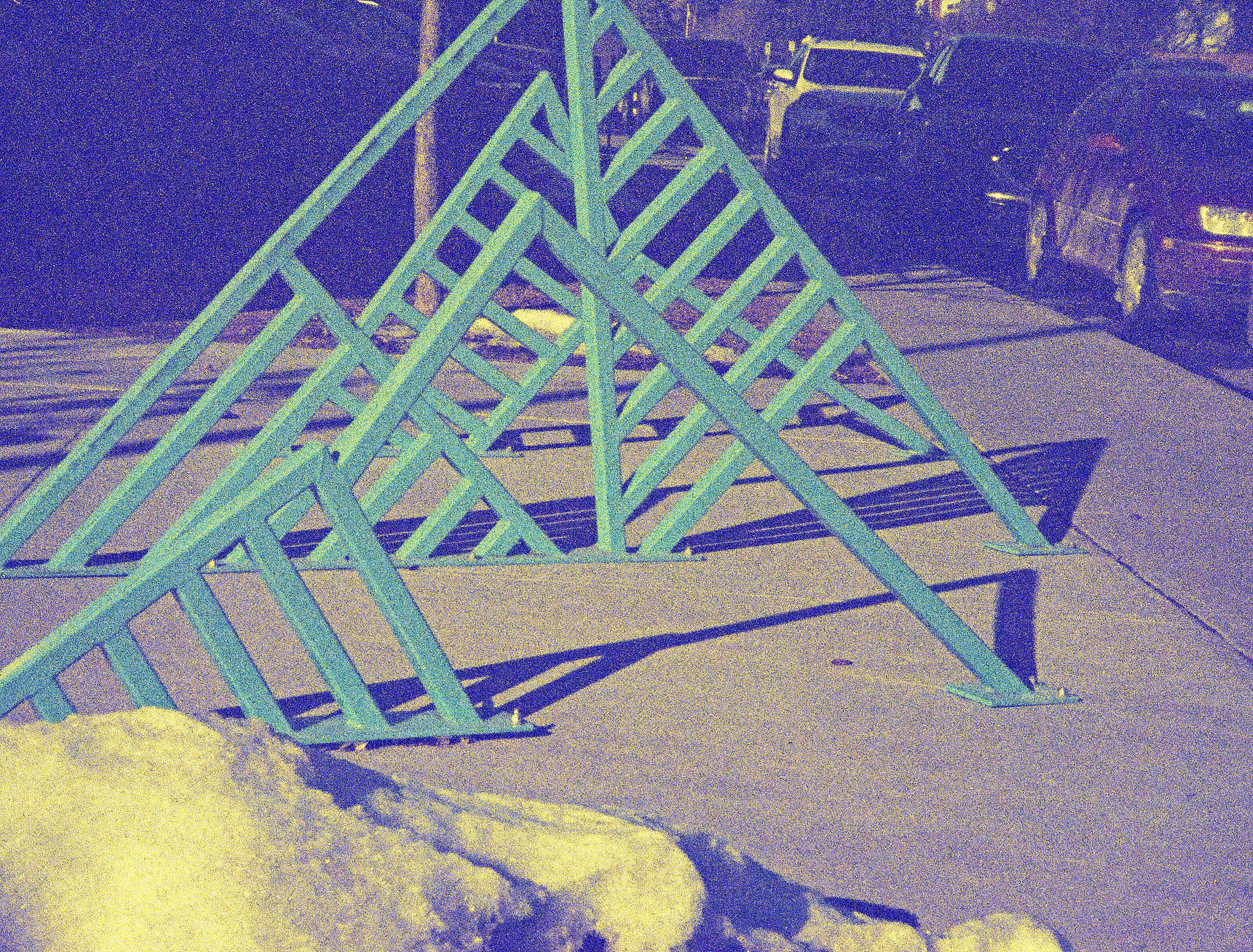 green steel sculpture on patio